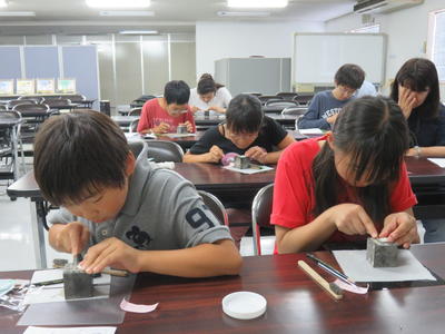 写真1:銀のストラップ作りに夢中な様子